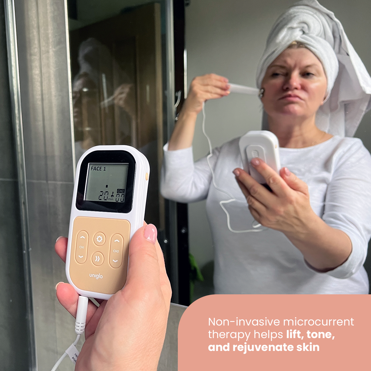 Woman using the Uniglo at a mirror; non-invasive microcurrent therapy helps lift, tone and rejuvenate skin