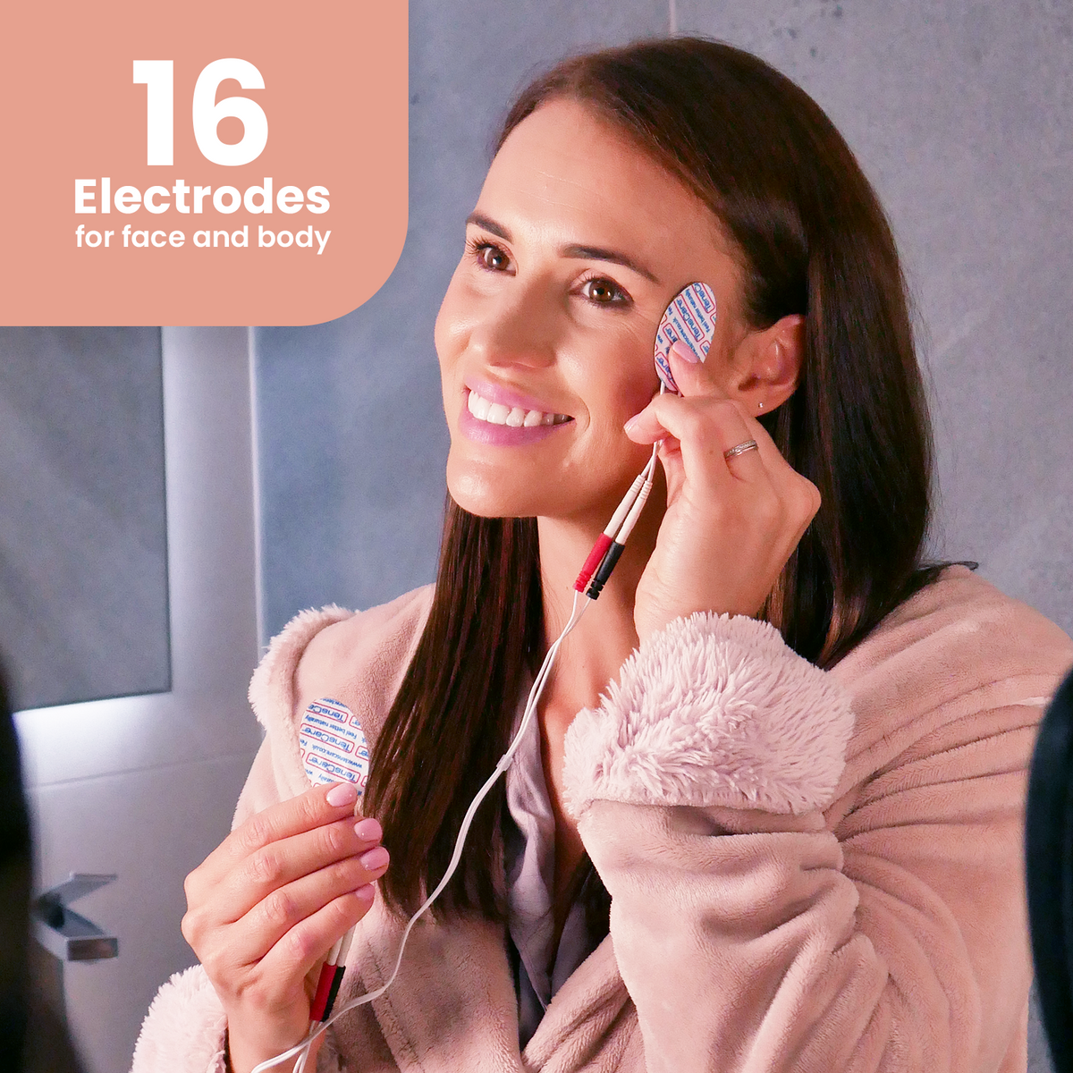 Woman applying Uniglo electrodes to her face; 16 electrodes for face and body