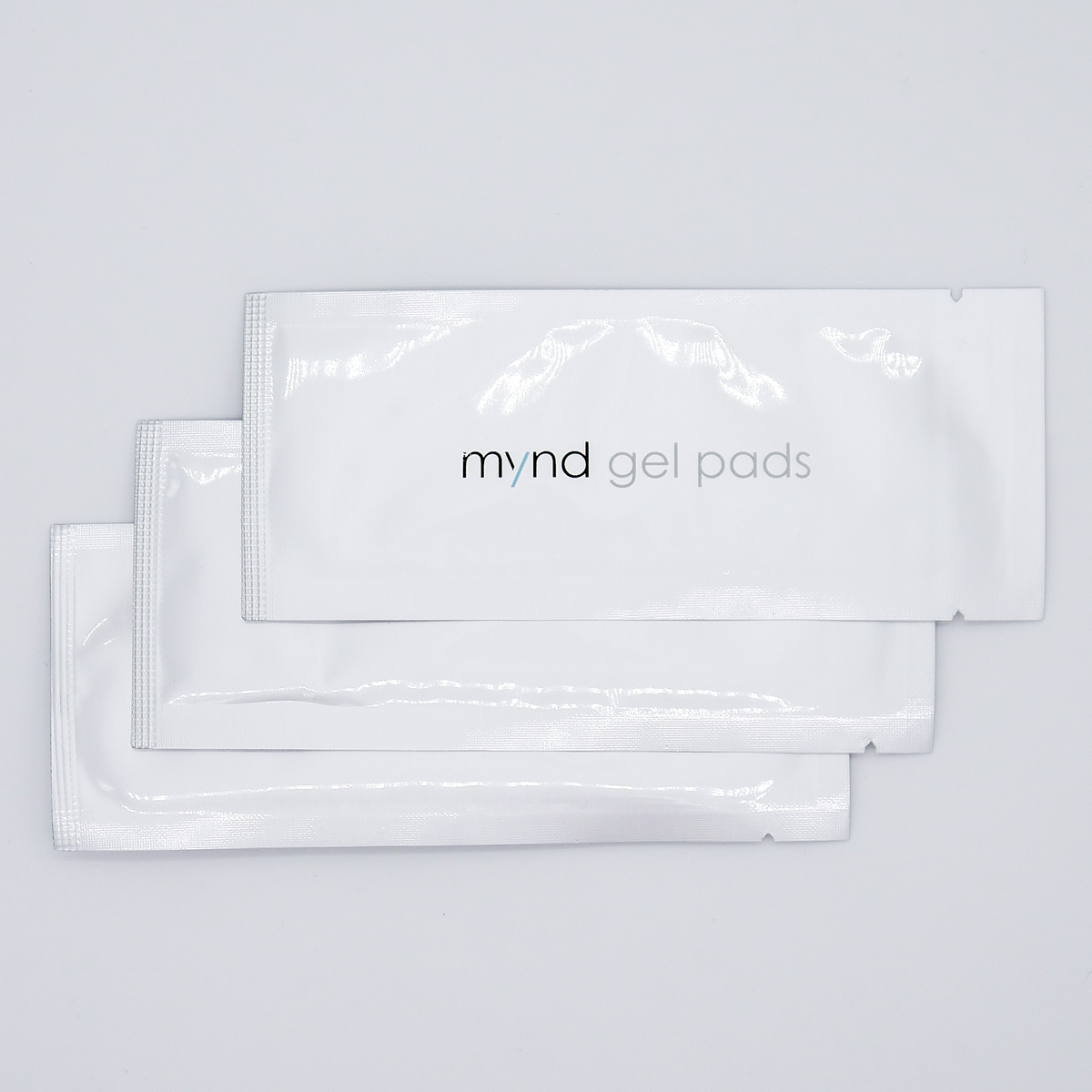Three sealed TensCare Mynd gel pad sachets fanned out