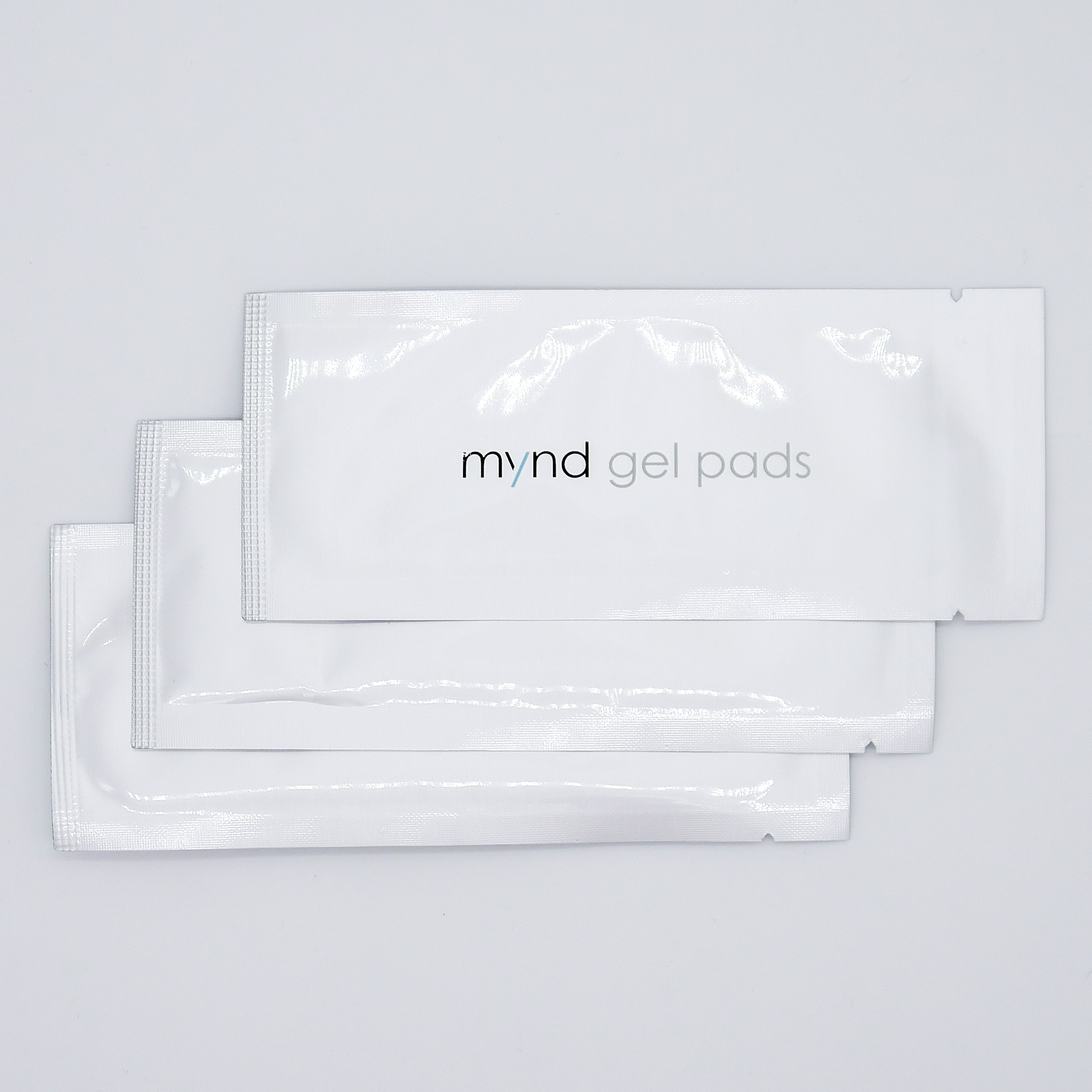 Three sealed TensCare Mynd gel pad sachets fanned out
