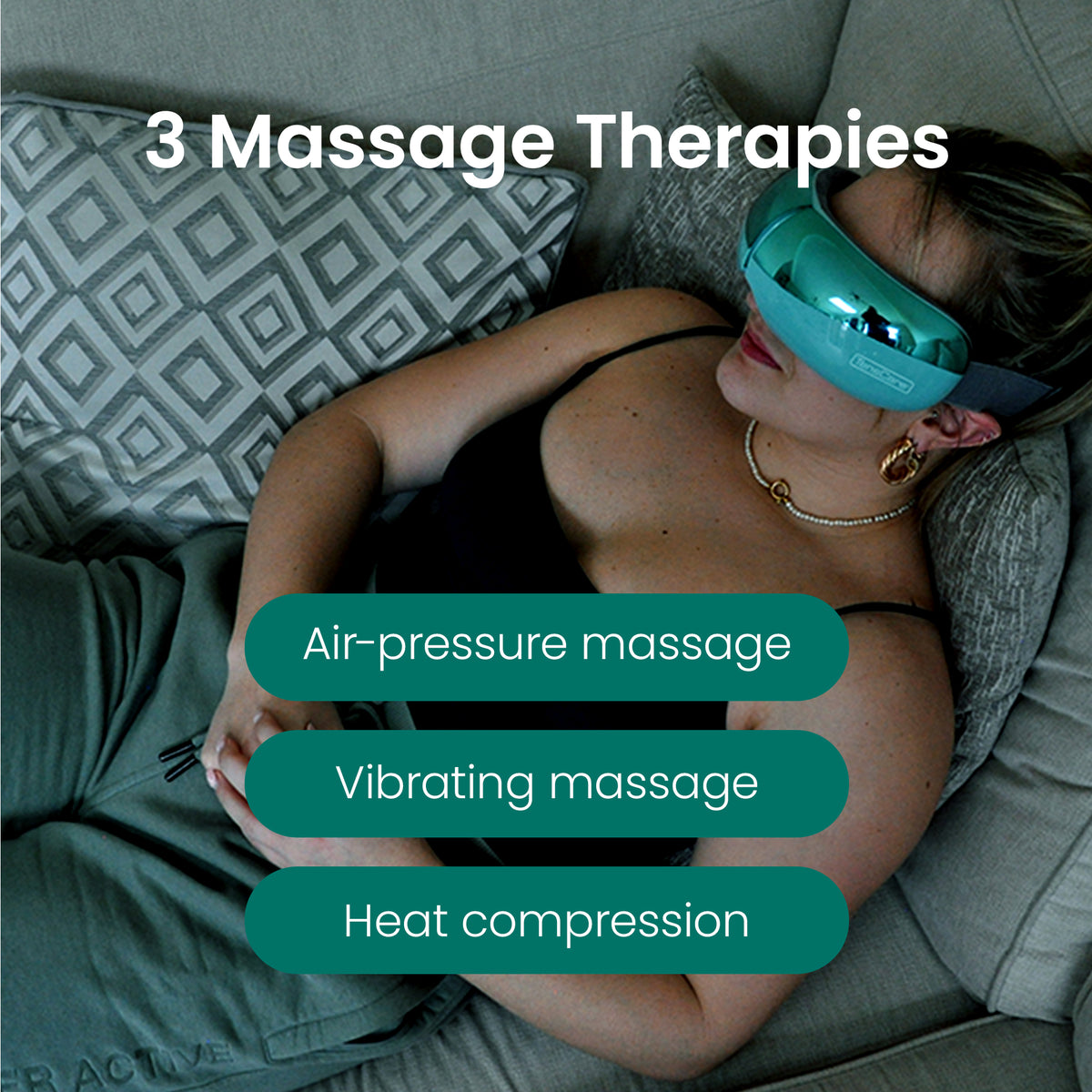 Woman on a sofa wearing the OKO, showing its 3 massage therapies: air-pressure, vibrating and heat compression