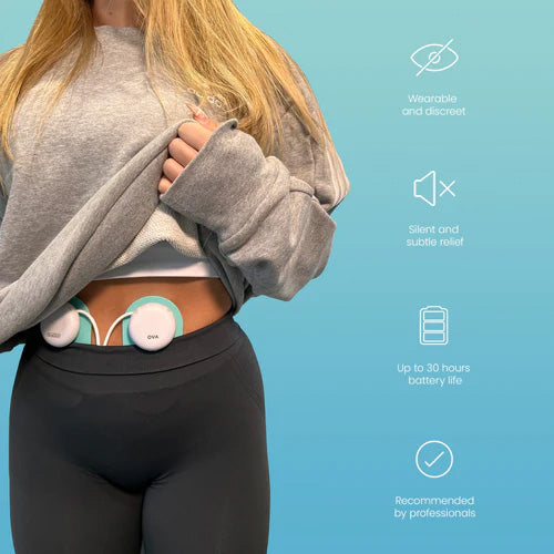 Woman lifting her top to show the Ova 3 pods worn on her abdomen; wearable, discreet and silent with up to 30 hours battery