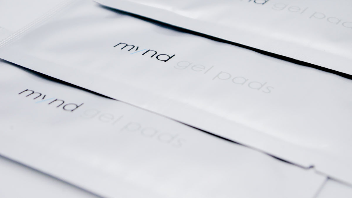Close-up of stacked TensCare Mynd gel pad sachets