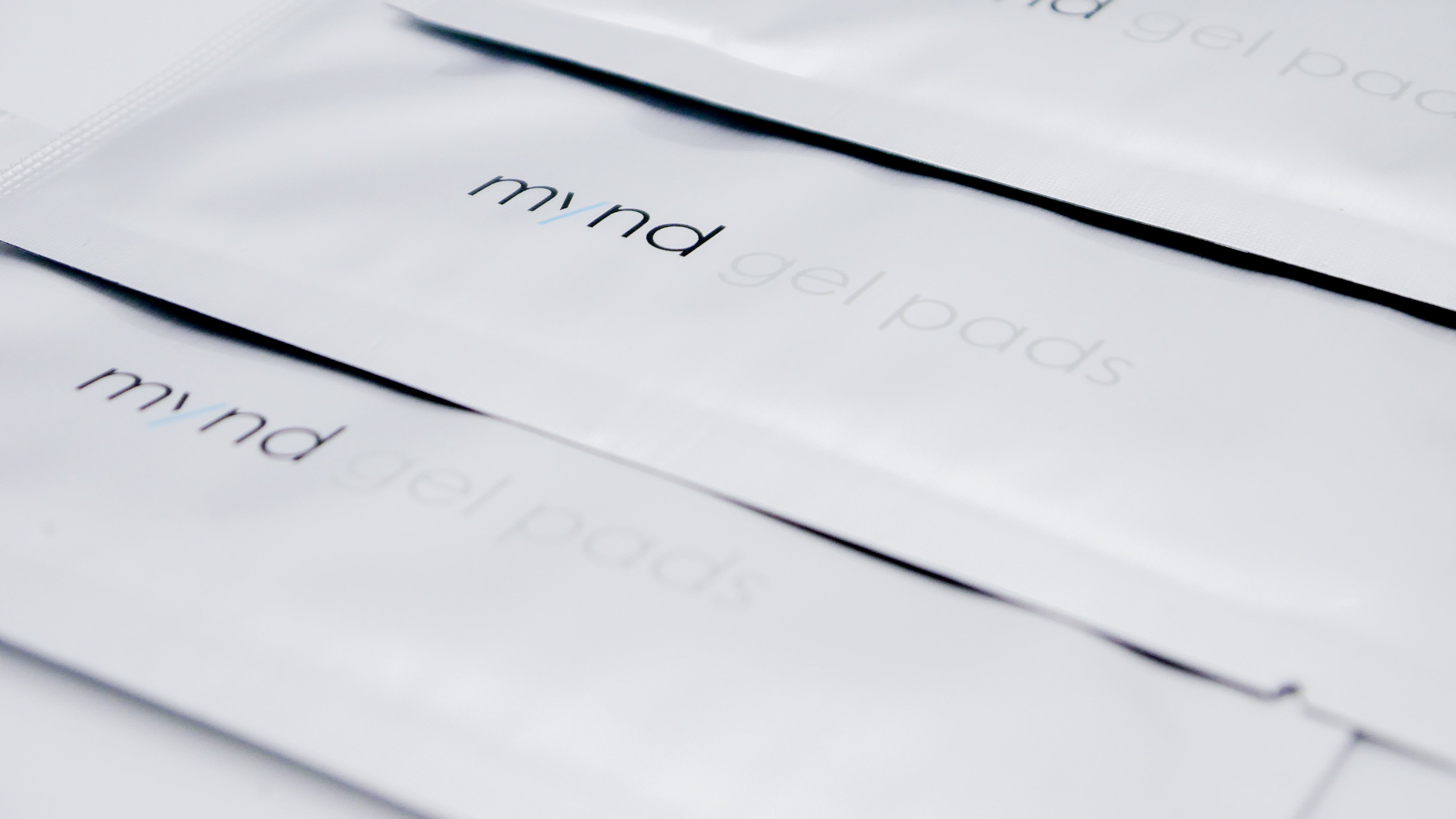 Close-up of stacked TensCare Mynd gel pad sachets