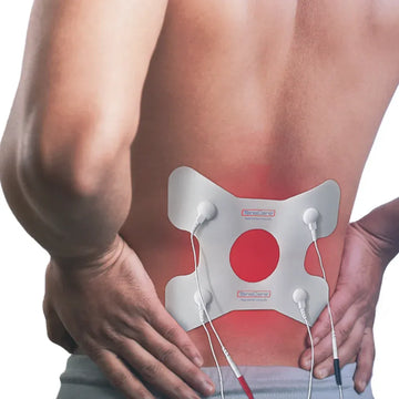 TensCare back pain electrode pad worn on a person's lower back, pain area highlighted in red