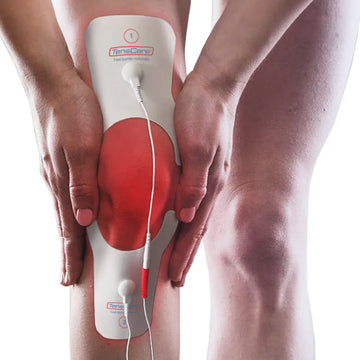 TensCare knee pain electrode pad wrapped around a knee, pain area highlighted in red