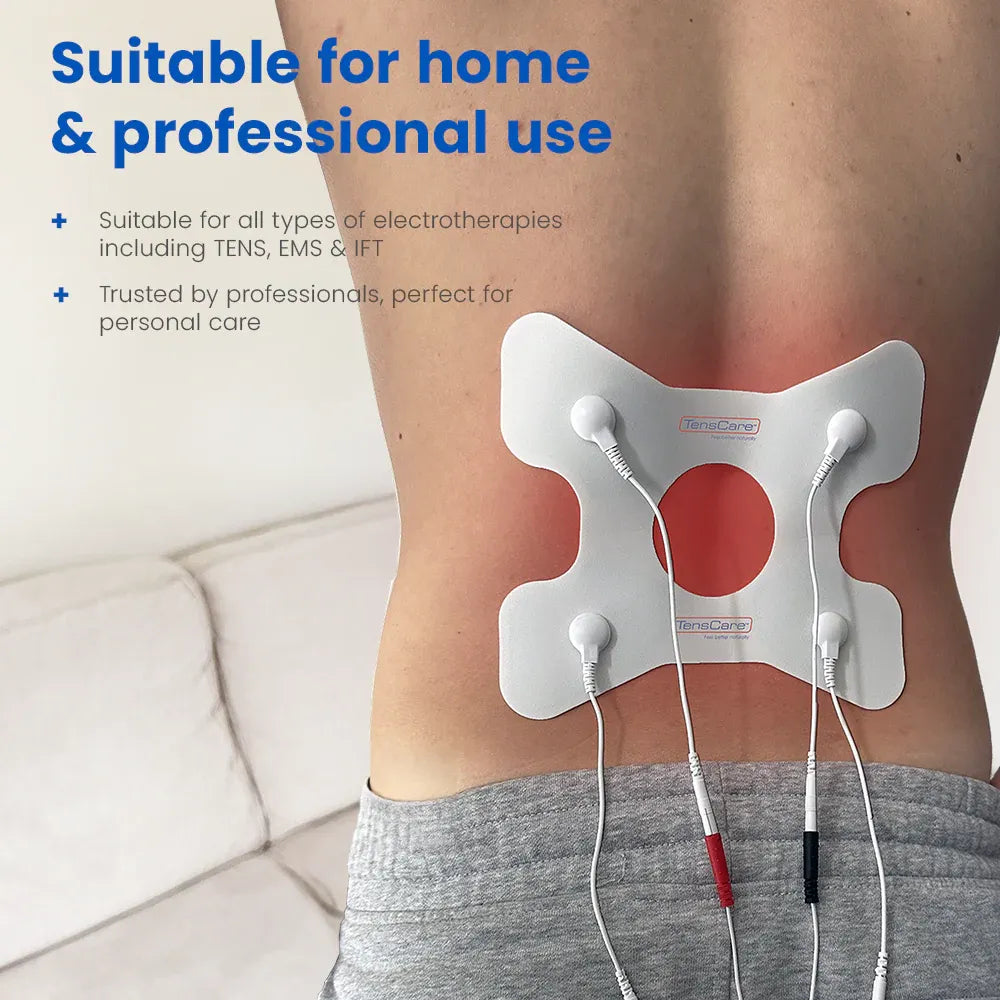 Person on a sofa wearing the TensCare back pain electrode pad on their lower back