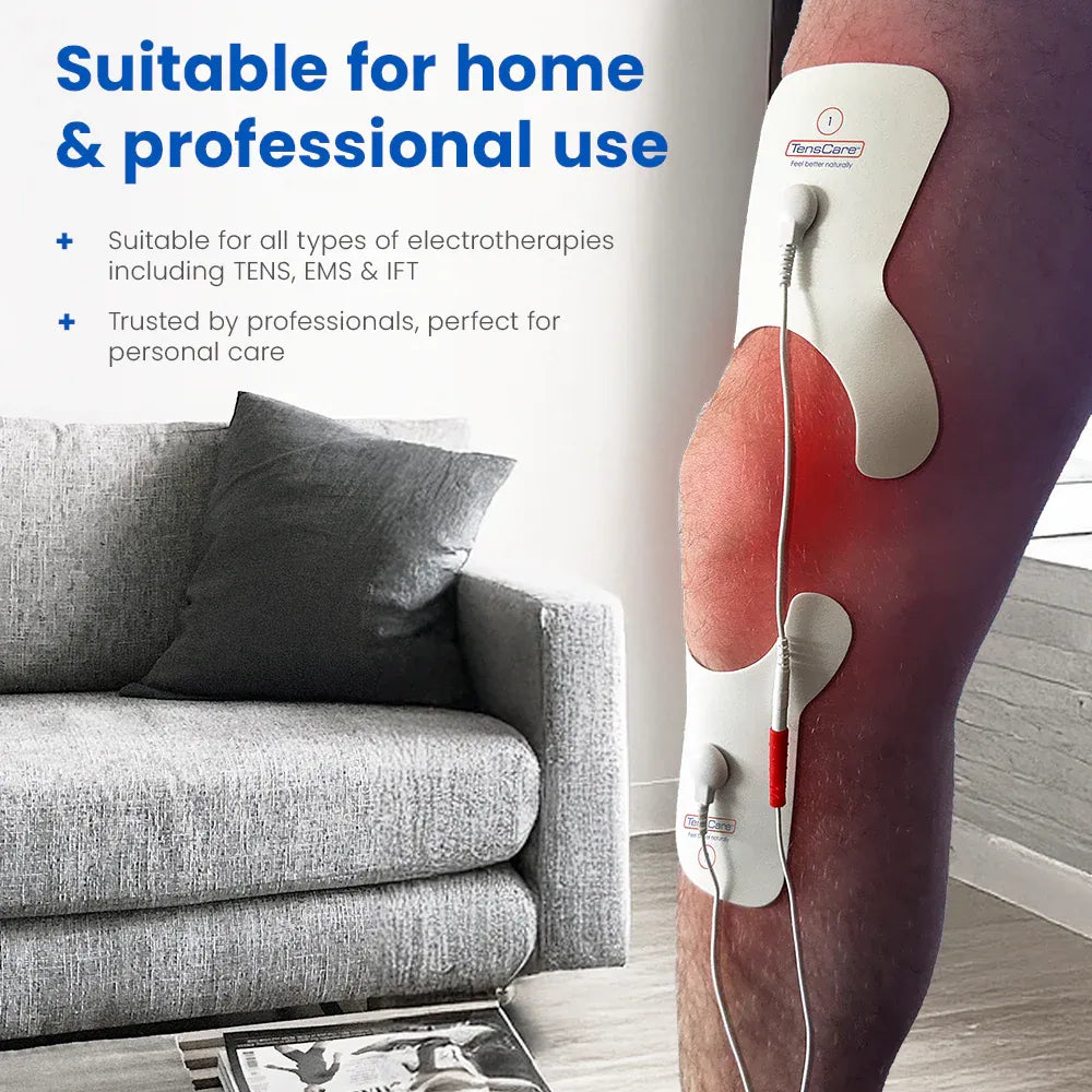 Person seated on a sofa wearing the TensCare knee pain electrode pad on their knee
